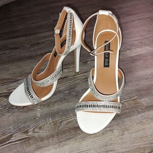 Izabella Rue Gwenyth Heels White heels with rhinestone detailing on band